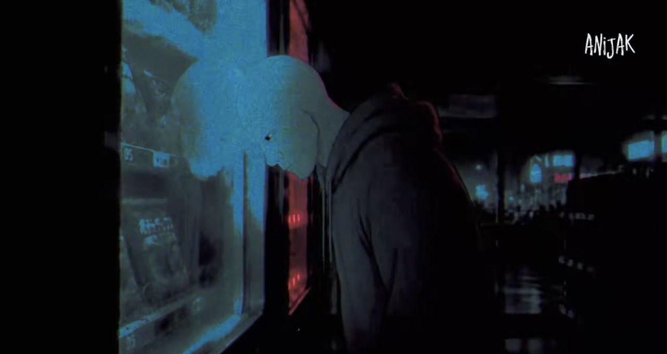 Anijak at a vending machine in a dark street at night